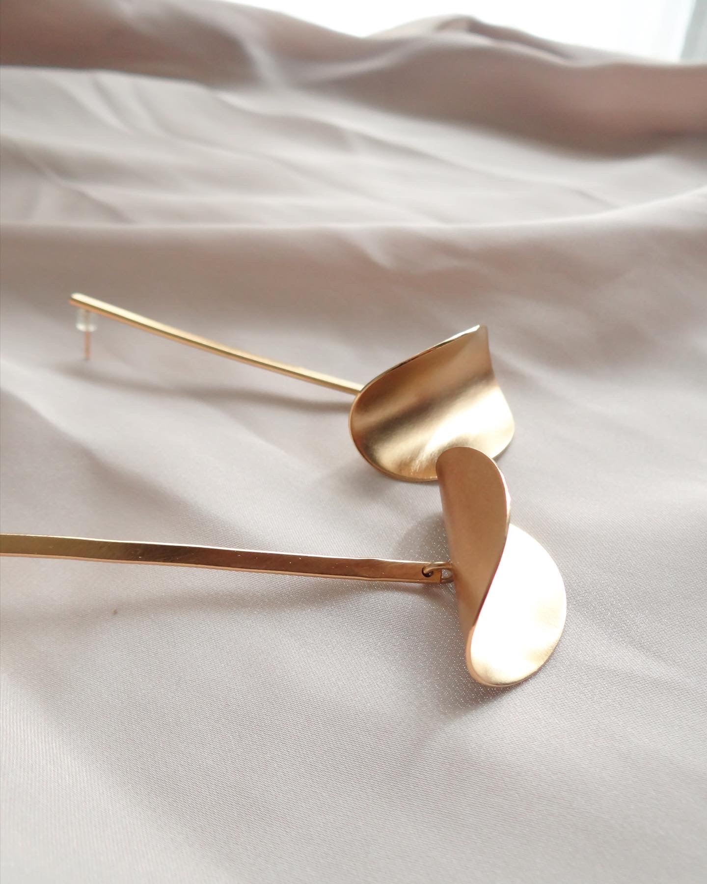 a unique pair of gold dangle drop earrings